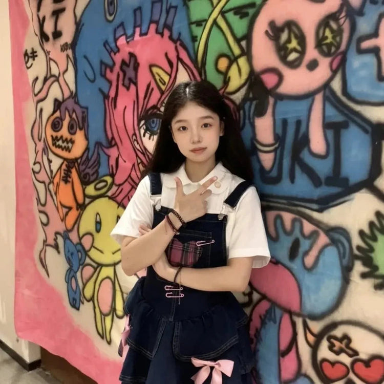 Pocket Full of Love Overall Dress styled over a white collared shirt against colorful artwork