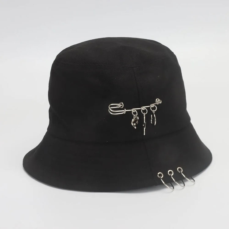 Side view of the Rebel Charm Bucket Hat in black showing a safety with charms and metal rings along the brim.