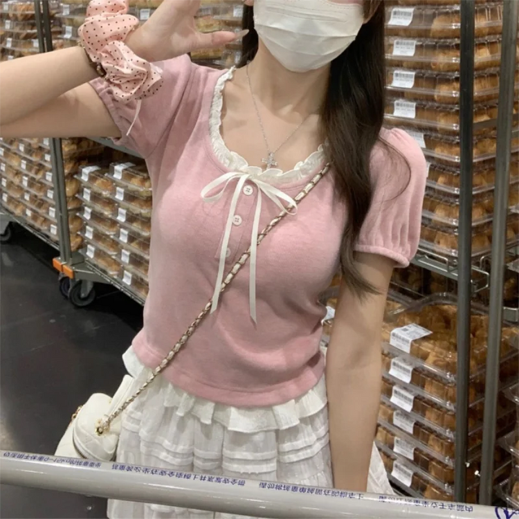 Pink Ribbon Knit Ballet Top styled casually with a crossbody bag and layered ruffle skirt