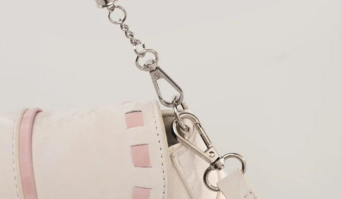 Close-up of the Ribbon Romance Shoulder Bag in cream, highlighting the detachable shoulder straps and interwoven ribbon detailing.