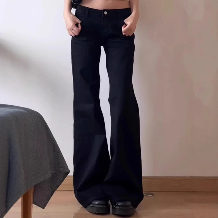 Model posing with their thumbs in the front pockets of the Rogue Rise Rigid Flare Jeans.