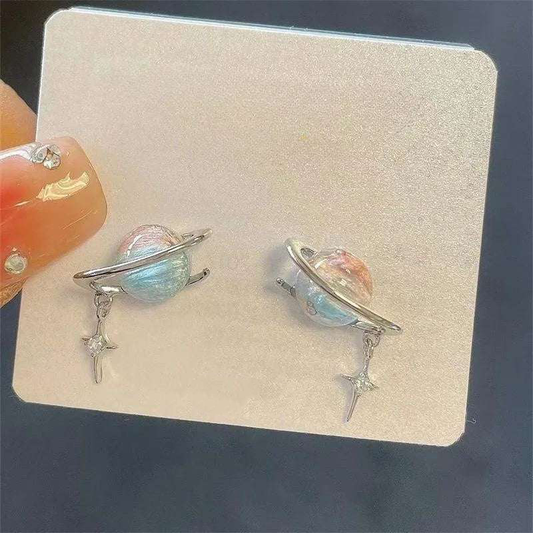 Saturn Spark Earrings with silver planet and sparkle rhinestones displayed on jewelry card