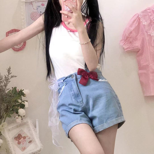 Scarlet Sweetheart High-Rise Shorts front styled pose, showcasing light blue denim, high waist, lace trim pockets, and red bow detail