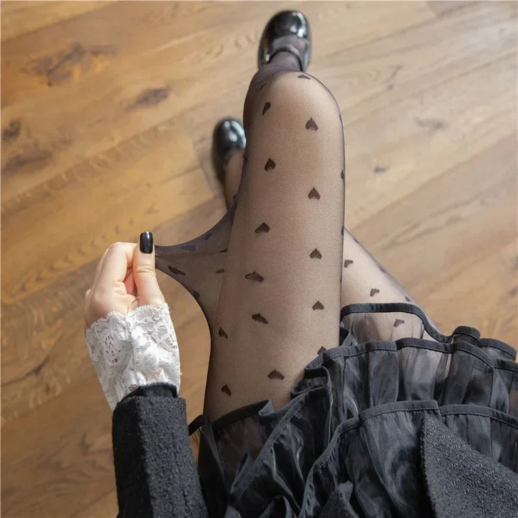 Scattered Heart Sheer Tights with black heart pattern shown on legs from above