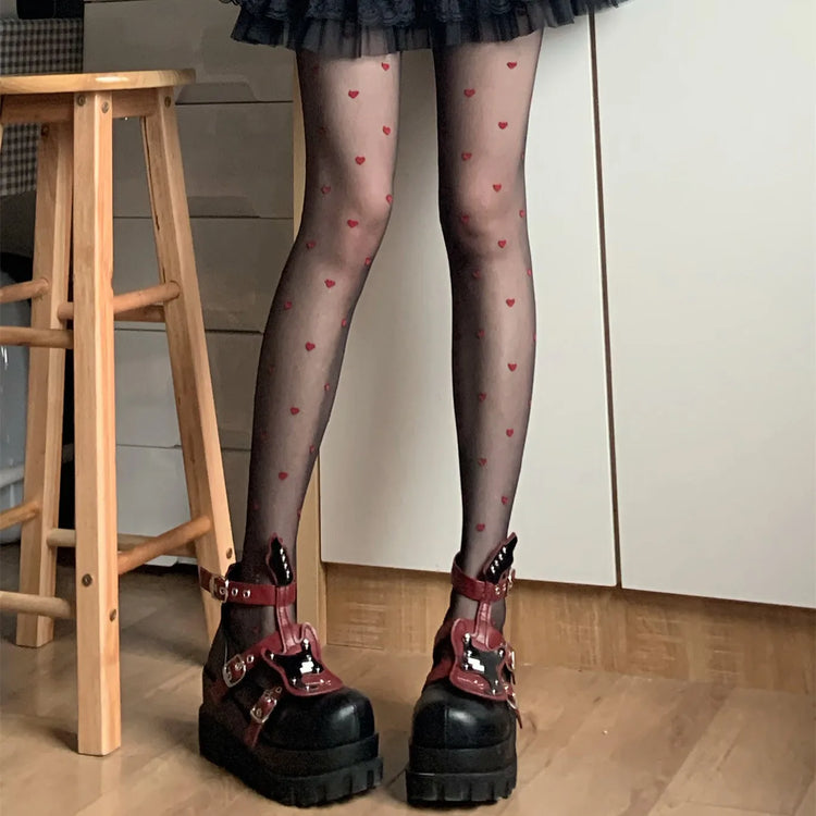 Scattered Heart Sheer Tights in red hearts shown from a standing pose