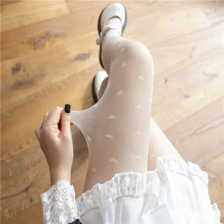 Scattered Heart Sheer Tights with white heart pattern styled with soft light outfit