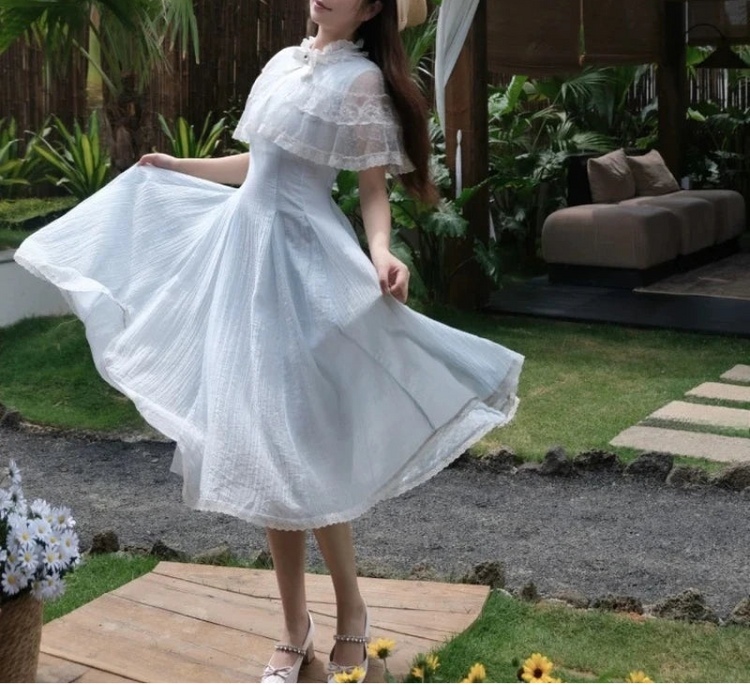 Model wearing Seraphina Lace Midi Dress outdoors twirling the mid-length skirt.