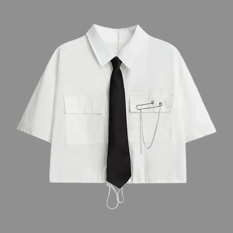 White short-sleeve cropped button-up shirt from the Shadow Chain Utility Set featuring a matching black tie, removable safety pin with chain, and adjustable drawstring waist.