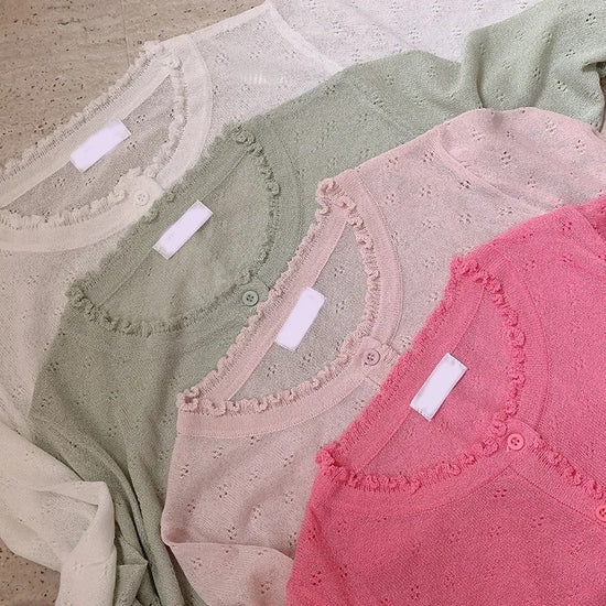 Four color options of the Sheer Sweetness Cardigan laid flat—white, green, blush pink, and hot pink.