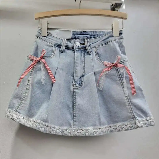 Light denim Southern Charm Mini Skort with layered red gingham and white lace bows on pockets and scalloped lace-trim hem