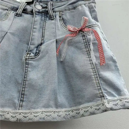 Close-up of hem on Southern Charm Mini Skort in light denim with bow and lace detail
