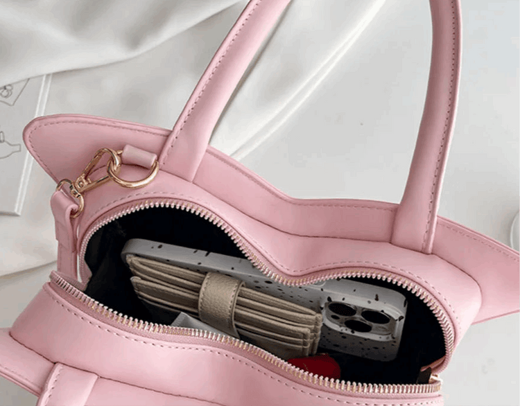 Close-up of interior zipper compartment of Sparkling Butterfly Handbag in pink and white