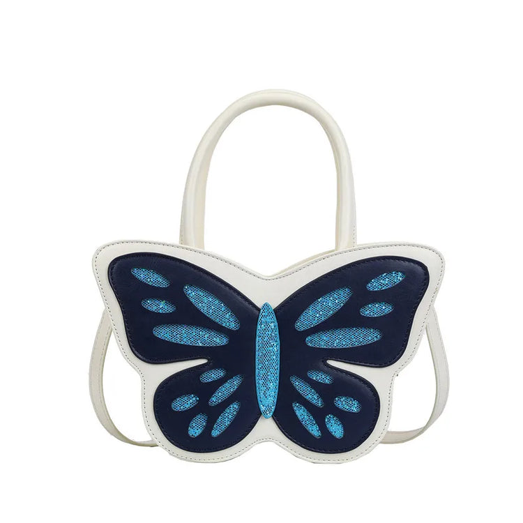 Flat lay of white and blue Sparkling Butterfly Handbag with glitter wings and structured shape