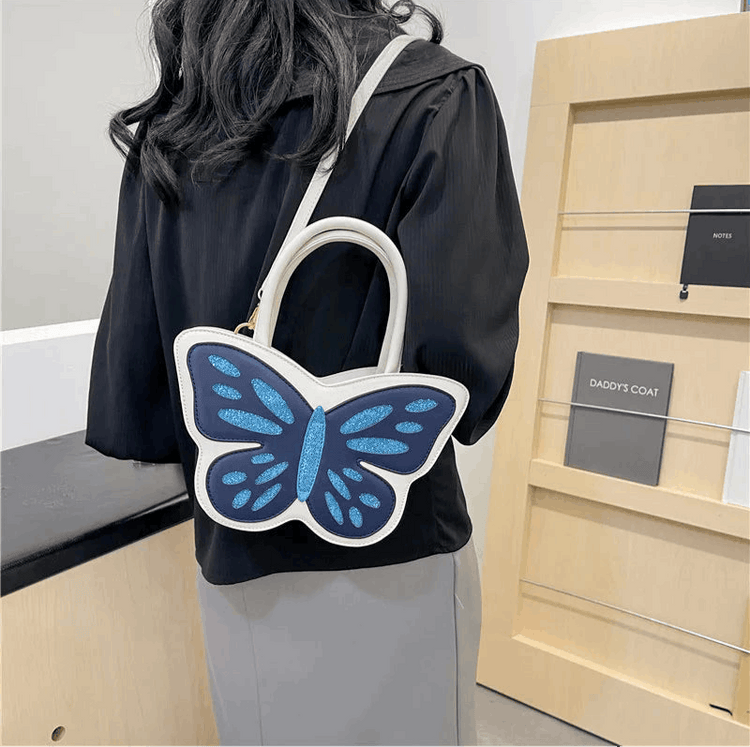 Model wearing Sparkling Butterfly Handbag in white and blue behind their back