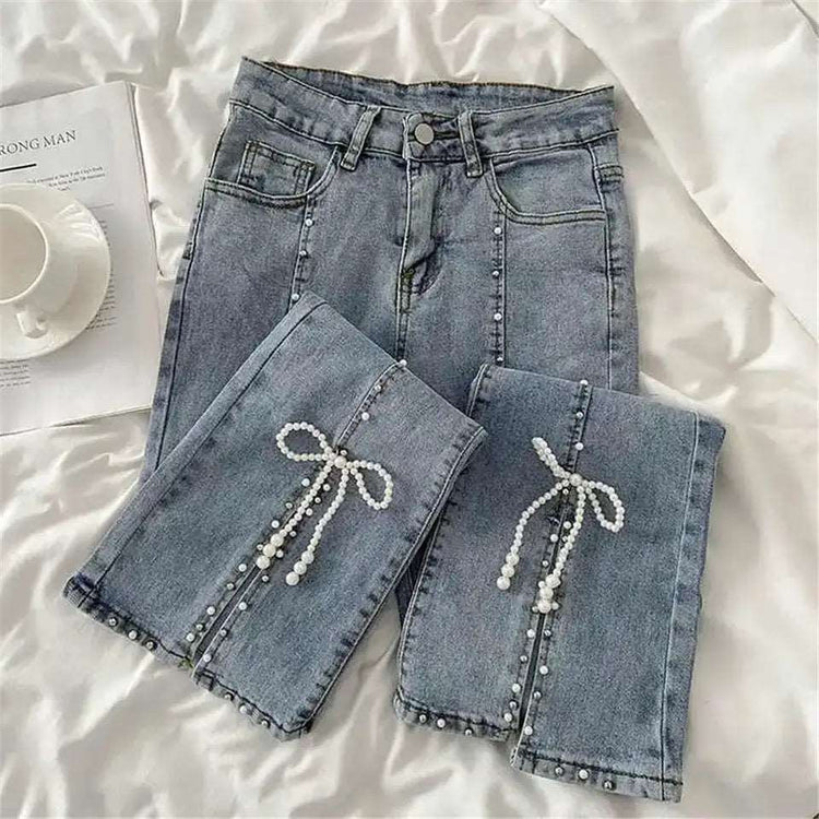 Front folded close-up view of pearl beading and bow at the slit of Split Statement Pearl Jeans