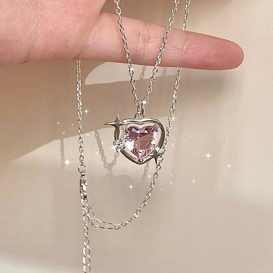 Hand holding the Starlit Love Necklace, highlighting pendant sparkle