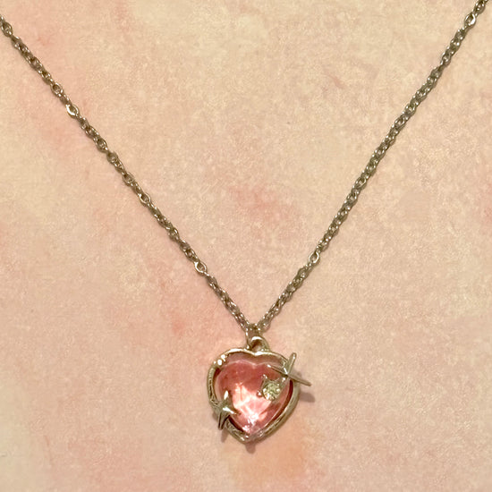 Starlit Love Necklace styled against a soft pink background