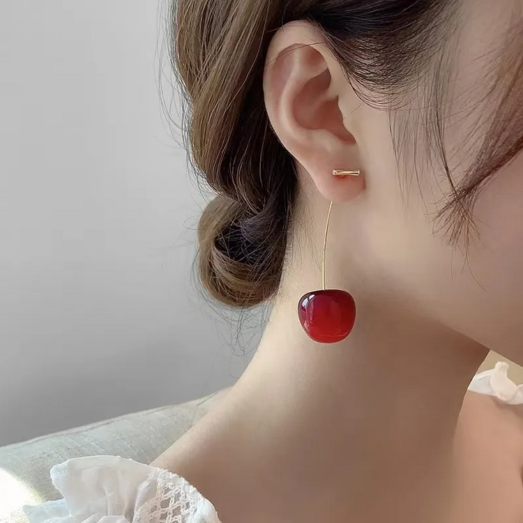 Close-up of model wearing dark red Sweet Cherry Earrings