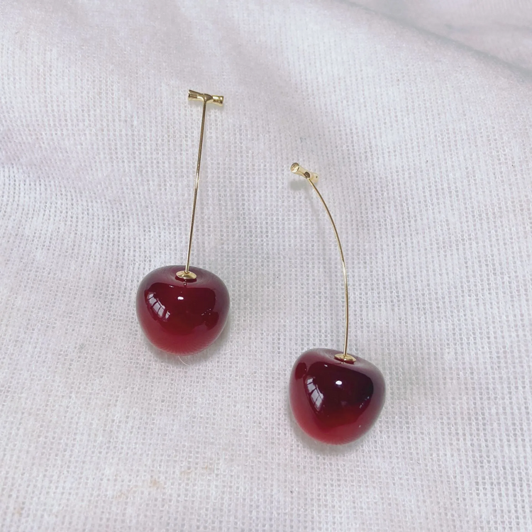 Dark red, large Sweet Cherry Earrings displayed on a white gauze-like background