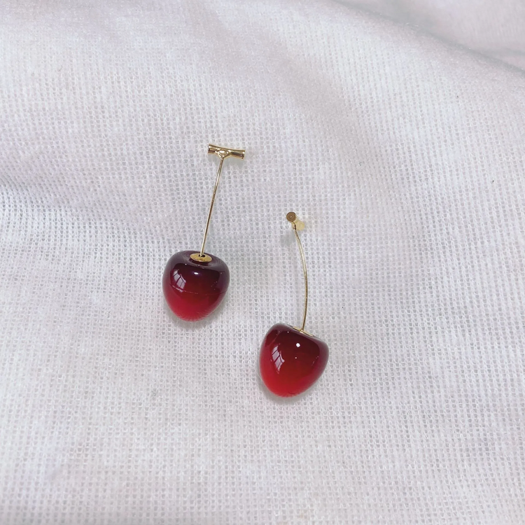 Dark red, small Sweet Cherry Earrings displayed on a white gauze-like background