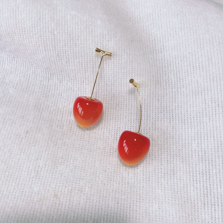 Vibrant red, small Sweet Cherry Earrings displayed on a white gauze-like background