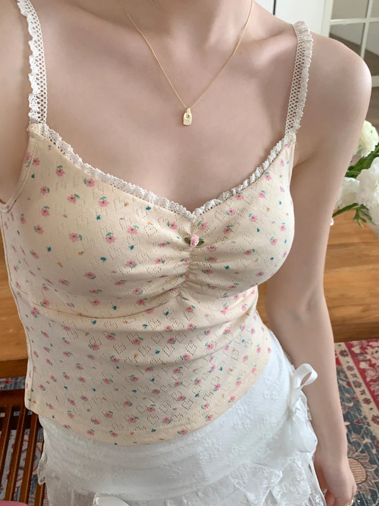 Close-up of model wearing apricot Sweet Flower Crop Top with pink floral print and lace straps.