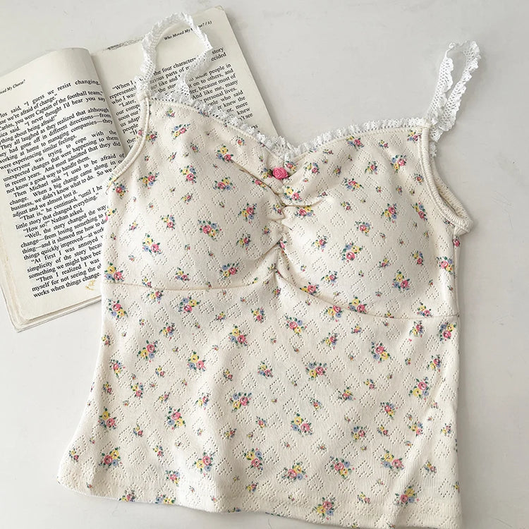 Flatlay of cream Sweet Flower Crop Top with multicolor mini floral print and hot pink center flower.