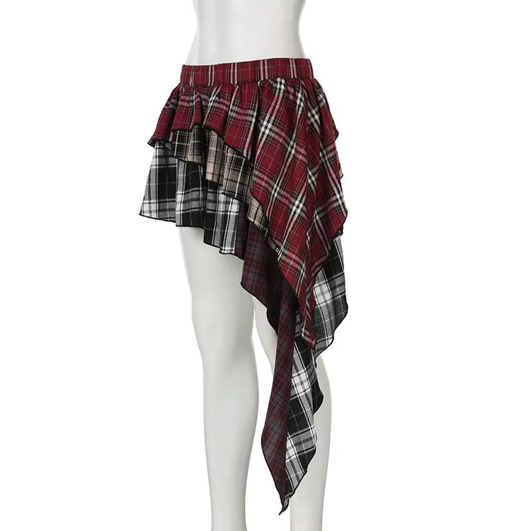 The Tilted Temper Tartan Skirt on a white mannequin at a three-fourths angle, showcasing mismatched plaid panels and angled hem