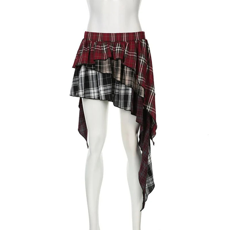 The frot of the Tilted Temper Tartan Skirt on a white mannequin, showcasing mismatched plaid panels and angled hem