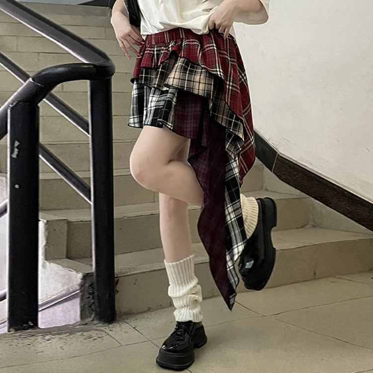 Side angle of model in the Tilted Temper Tartan Skirt, showing different lengths of the layers