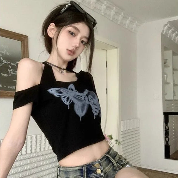Model wearing Whispering Wings Open Shoulder Top with graffiti-style butterfly print, side view