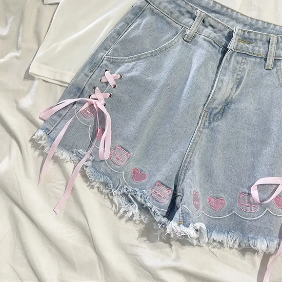Detailed view of pink animal and heart embroidery on Wildly Lovable Party Animal Shorts