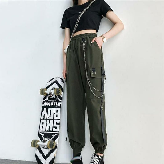 Front view of model wearing army green Chain Reaction Cargo Joggers showing flap pocket and hanging chain