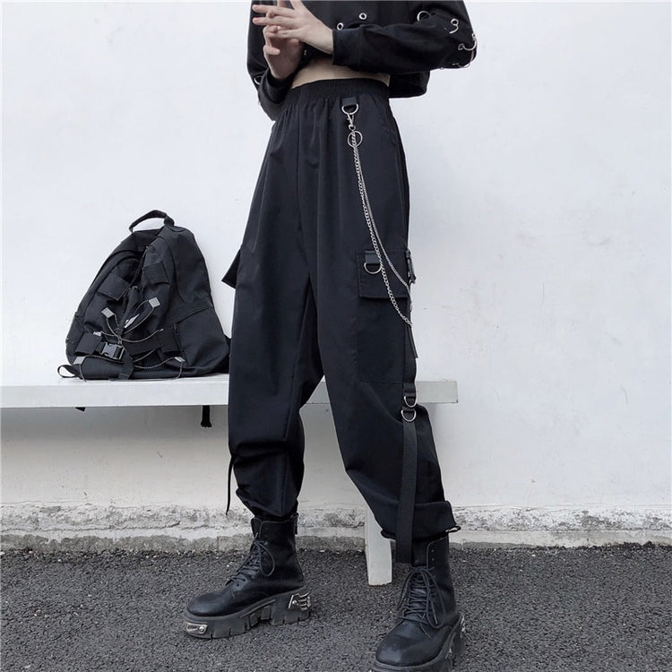 Angled view of model wearing black Chain Reaction Cargo Joggers with metal chain attached