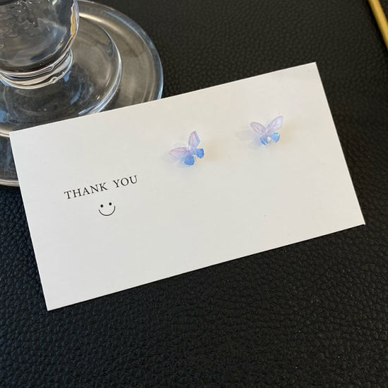 Dreamlit Butterfly Stud Earrings in a dreamy blend of purple and blue hues.