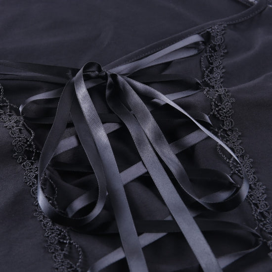 Detail shot of neckline and satin lace-up ribbon at the front of Petal Noir Lace-Up Top