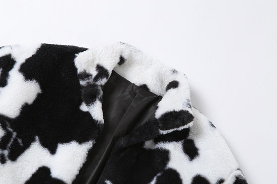 Close-up of faux fur collar and cow print texture on Udderly Wild Jacket