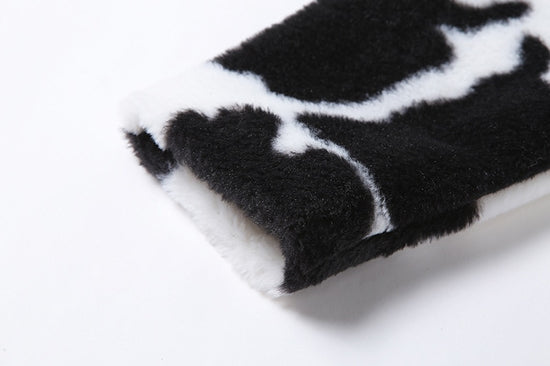 Close-up of faux fur sleeve and cow print texture on Udderly Wild Jacket