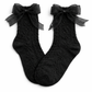 Flat lay of the Innocent Mischief Lace Socks in black with tulle bow.