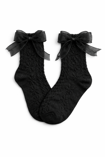 Flat lay of the Innocent Mischief Lace Socks in black with tulle bow.
