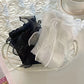 Styled folded view of the white and black versions of the Innocent Mischief Lace Socks with tulle bow.