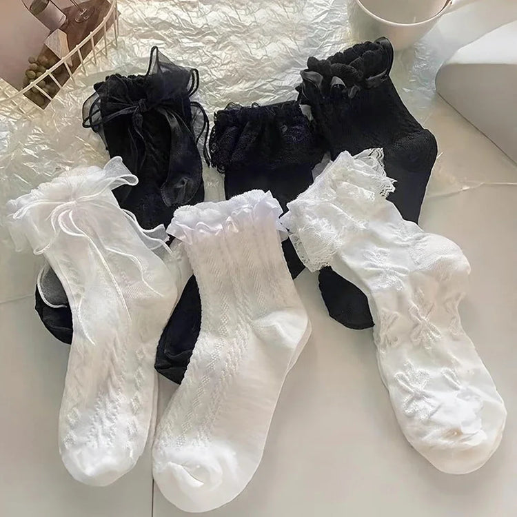 All styles of the Innocent Mischief Lace Socks in a styled flat lay.