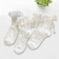 All three styles of the Innocent Mischief Lace Socks in white.
