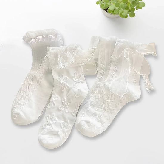 All three styles of the Innocent Mischief Lace Socks in white.