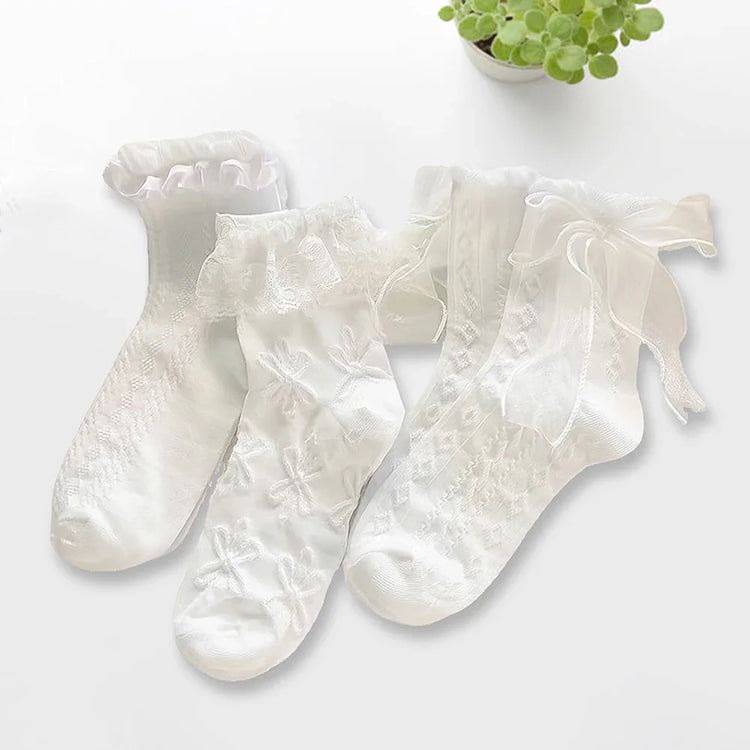 All three styles of the Innocent Mischief Lace Socks in white.