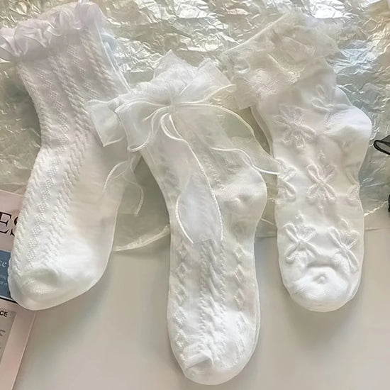 All three styles of the Innocent Mischief Lace Socks in white.