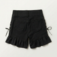 Back view of Two Moody Originals: Pretty Dangerous Shorts featuring custom ruffle hems and black denim construction.