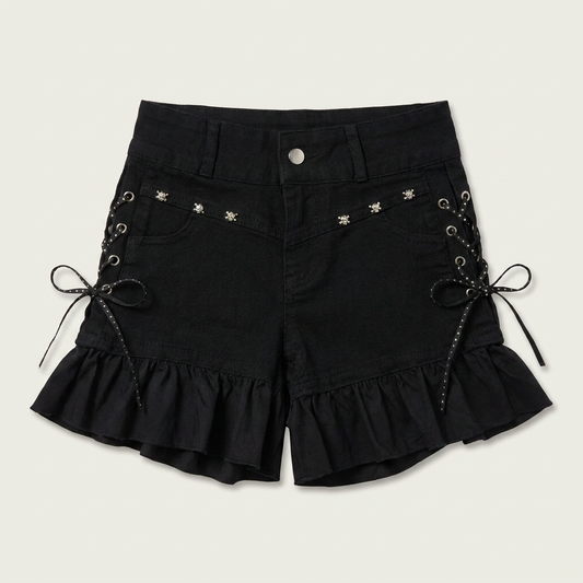 Two Moody Originals: Pretty Dangerous Shorts in black denim with custom ruffle hems, skull embellishments, and studded ribbon side lacing.