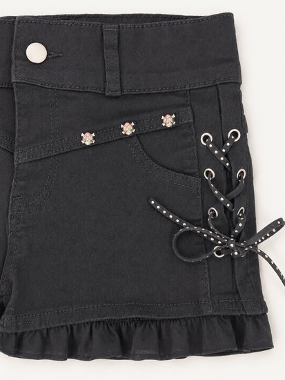 Detailed view of Two Moody Originals: Pretty Dangerous Shorts featuring studded ribbon side lacing, metal grommets, and skull embellishments.