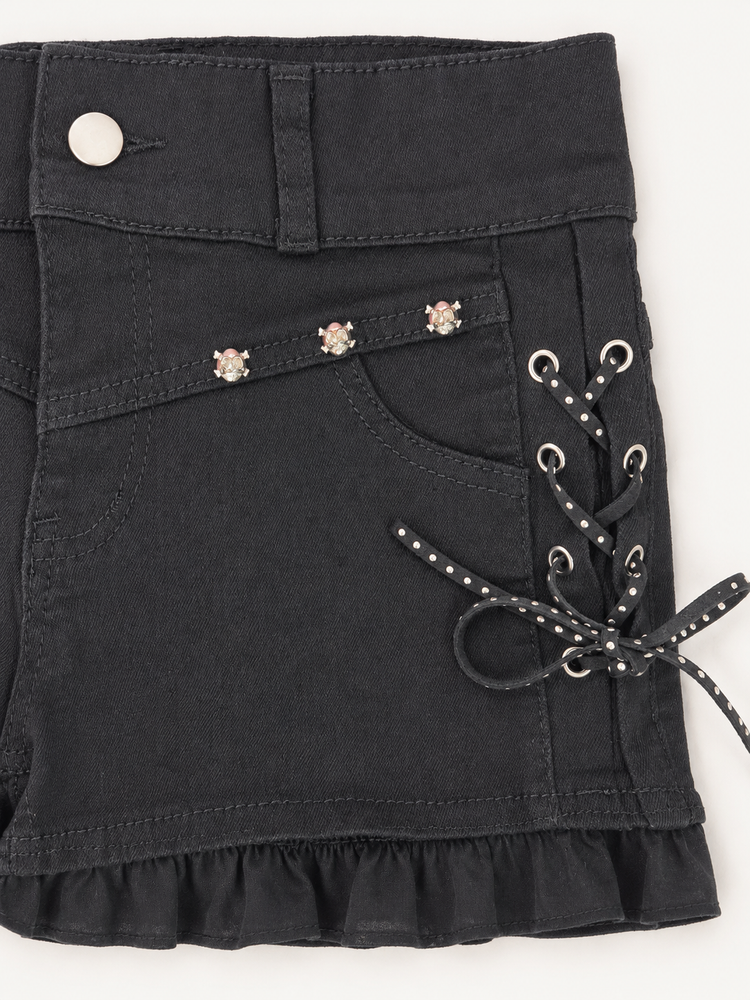 Detailed view of Two Moody Originals: Pretty Dangerous Shorts featuring studded ribbon side lacing, metal grommets, and skull embellishments.